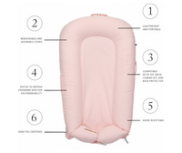 an image of a baby bed in pink color dockatot